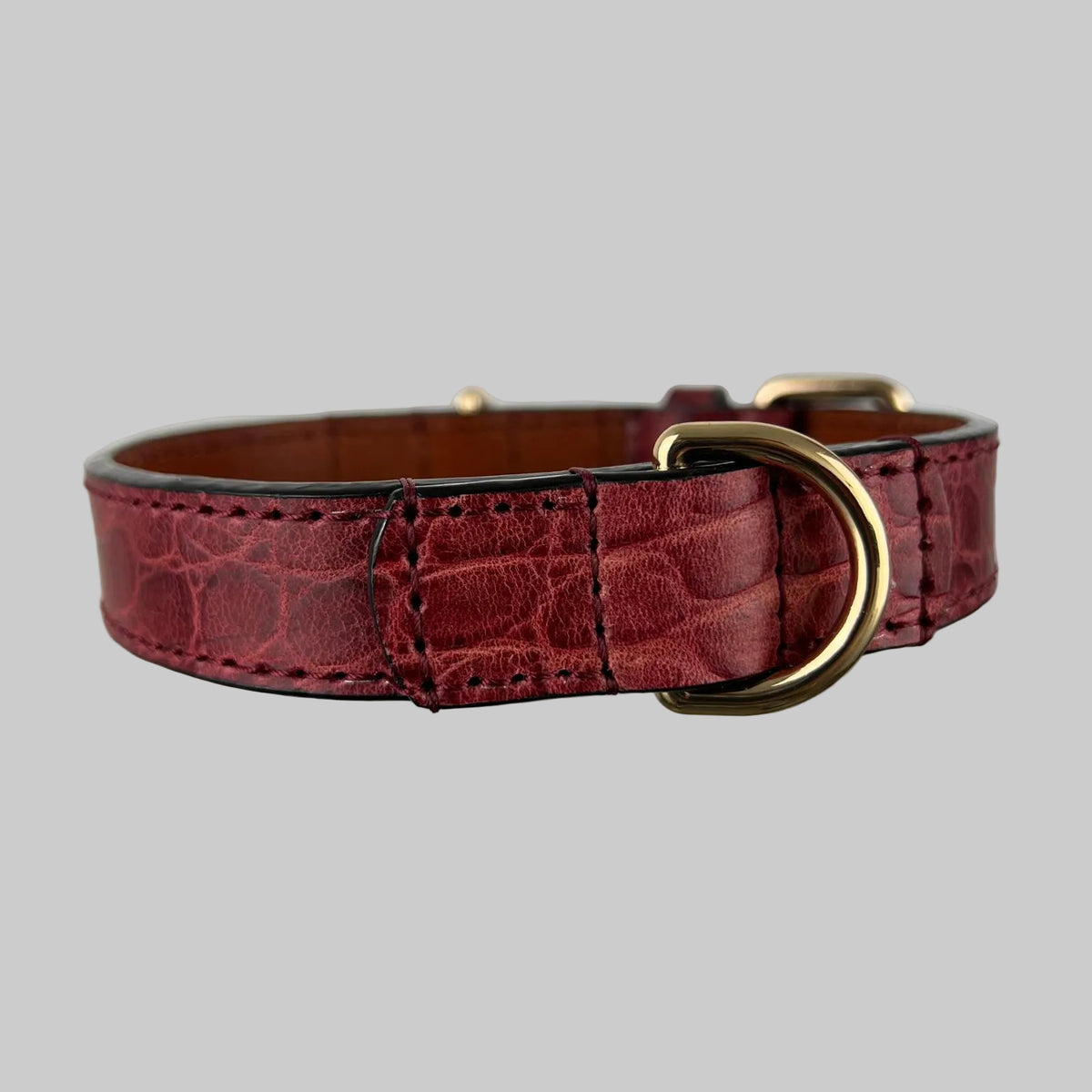 Handcrafted red crocodile leather dog collar showing rear D-ring and reinforced stitched construction