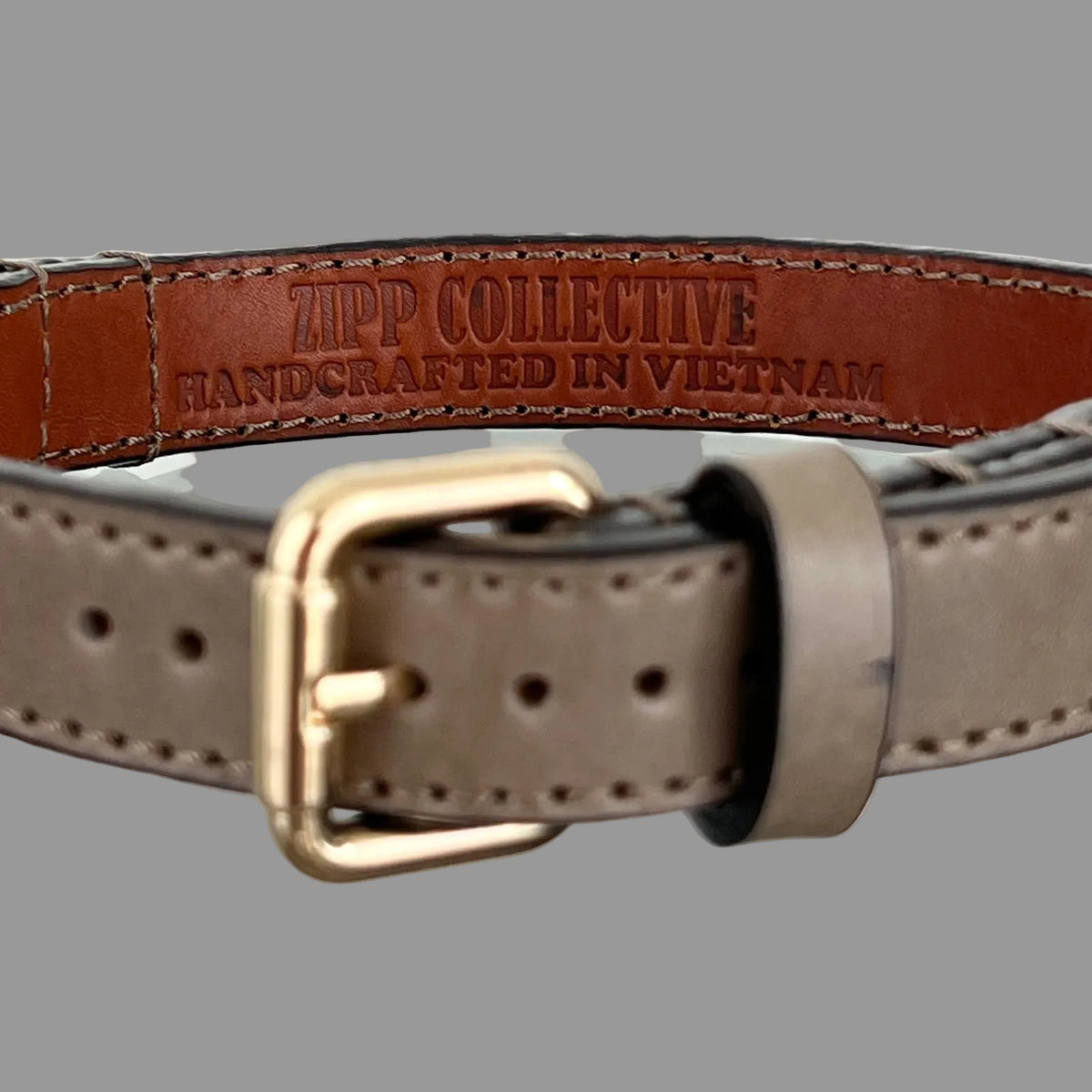 Handcrafted taupe leather dog collar showing ZIPP COLLECTIVE stamp