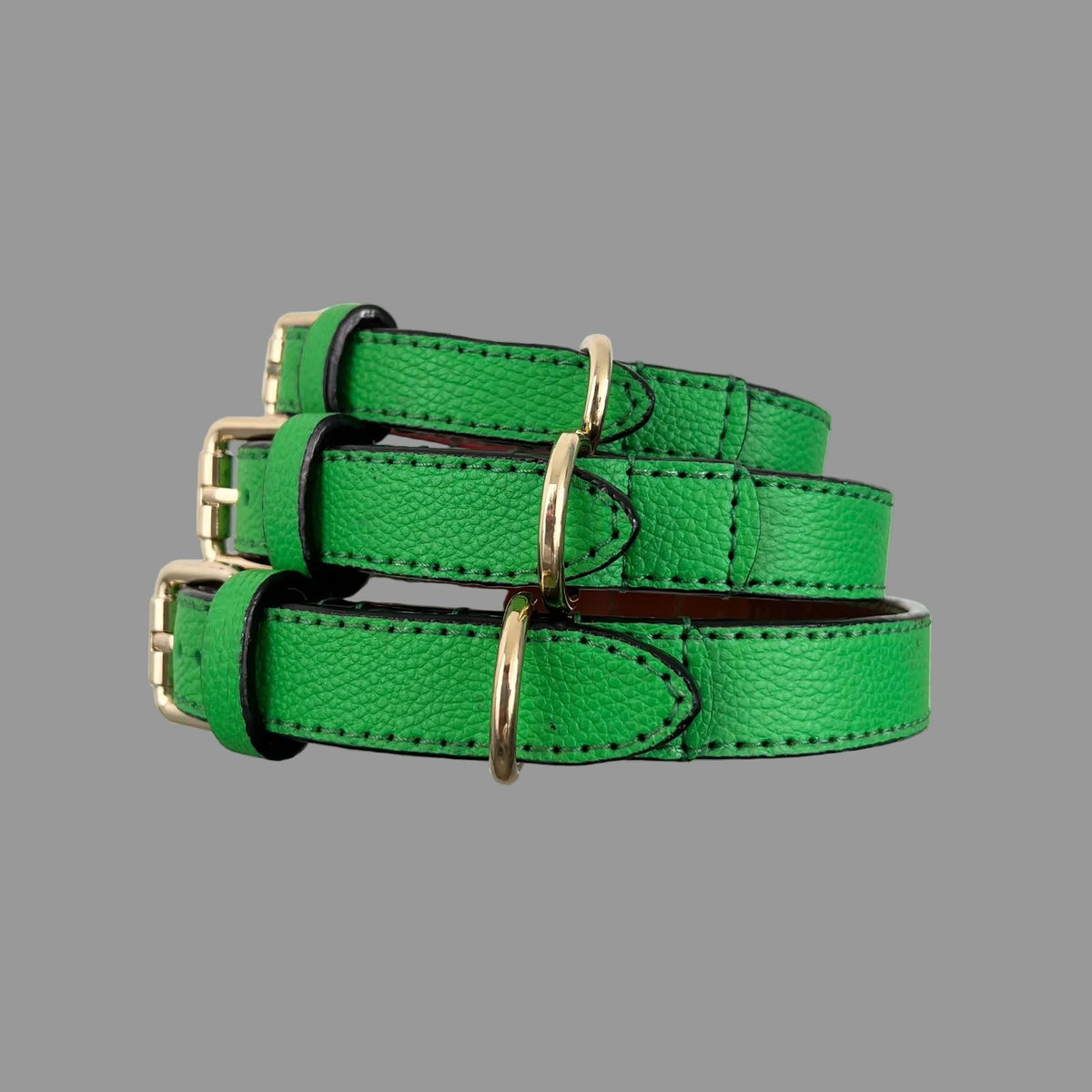 Bright green cowhide dog collars showing pebbled leather grain
