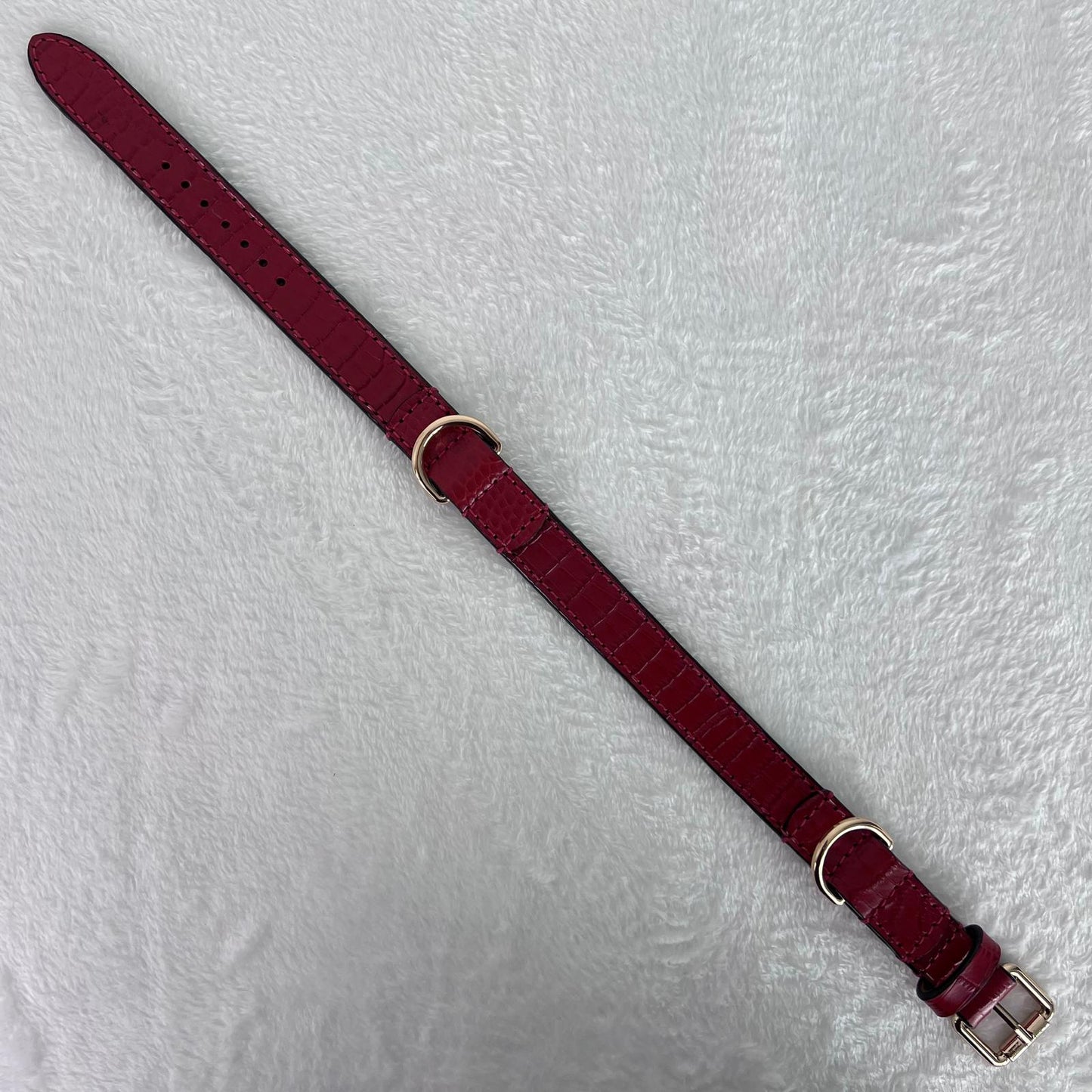 Full-length ruby red embossed leather dog collar with seven adjustment holes
