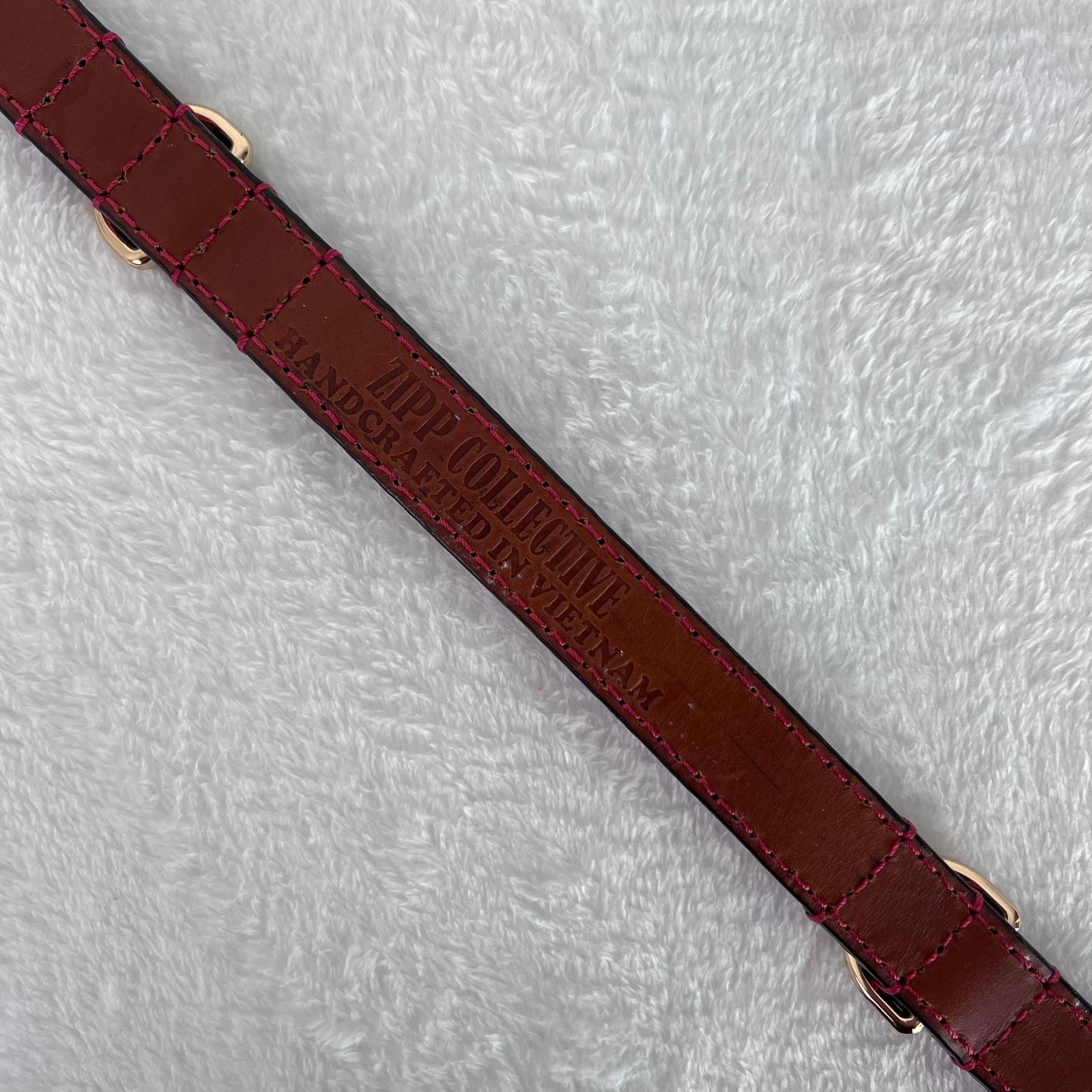 Genuine leather lining and handcrafted construction of ruby red dog collar