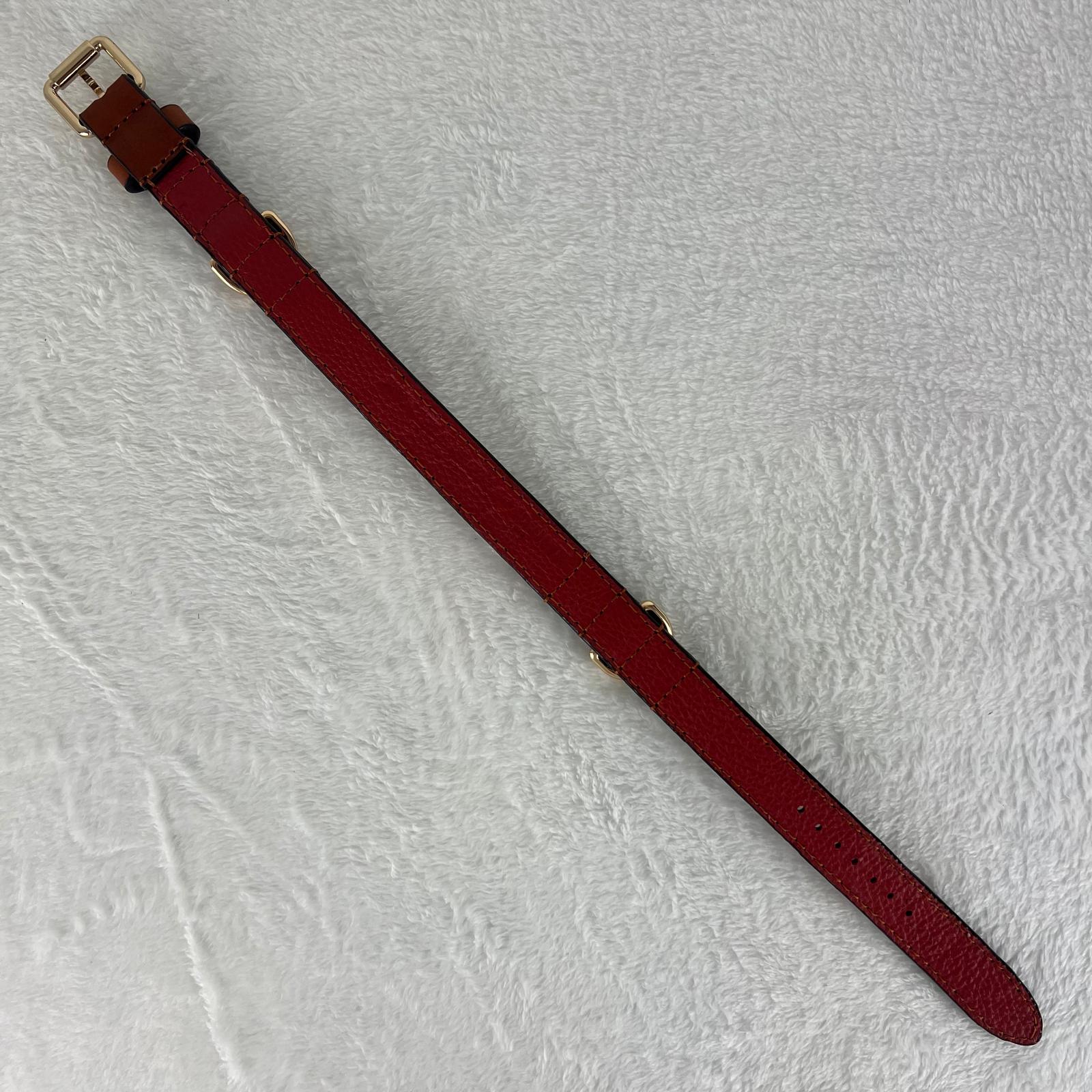 Full-length cognac brown dog collar showing red soft pebbled cowhide lining and seven adjustment holes